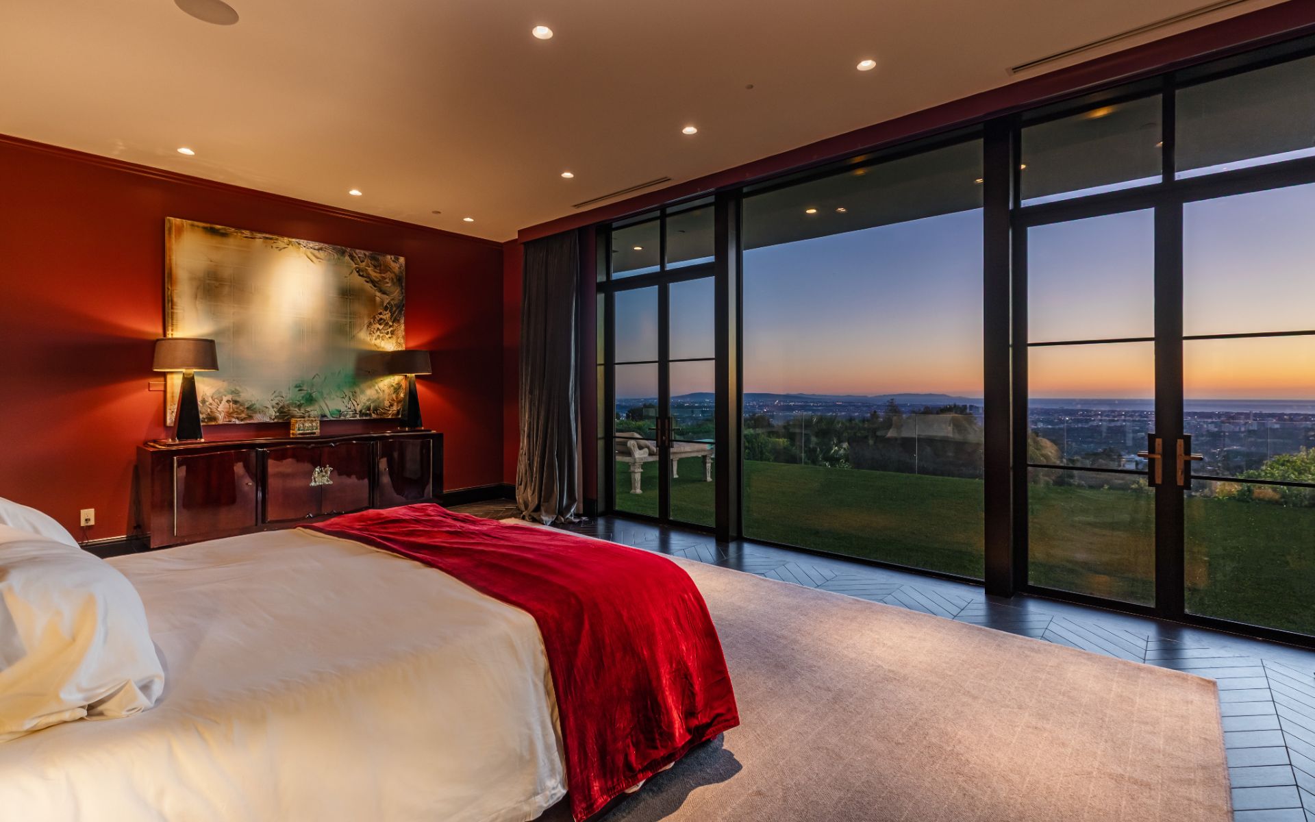 Primary suite opening to the lawn at sunset