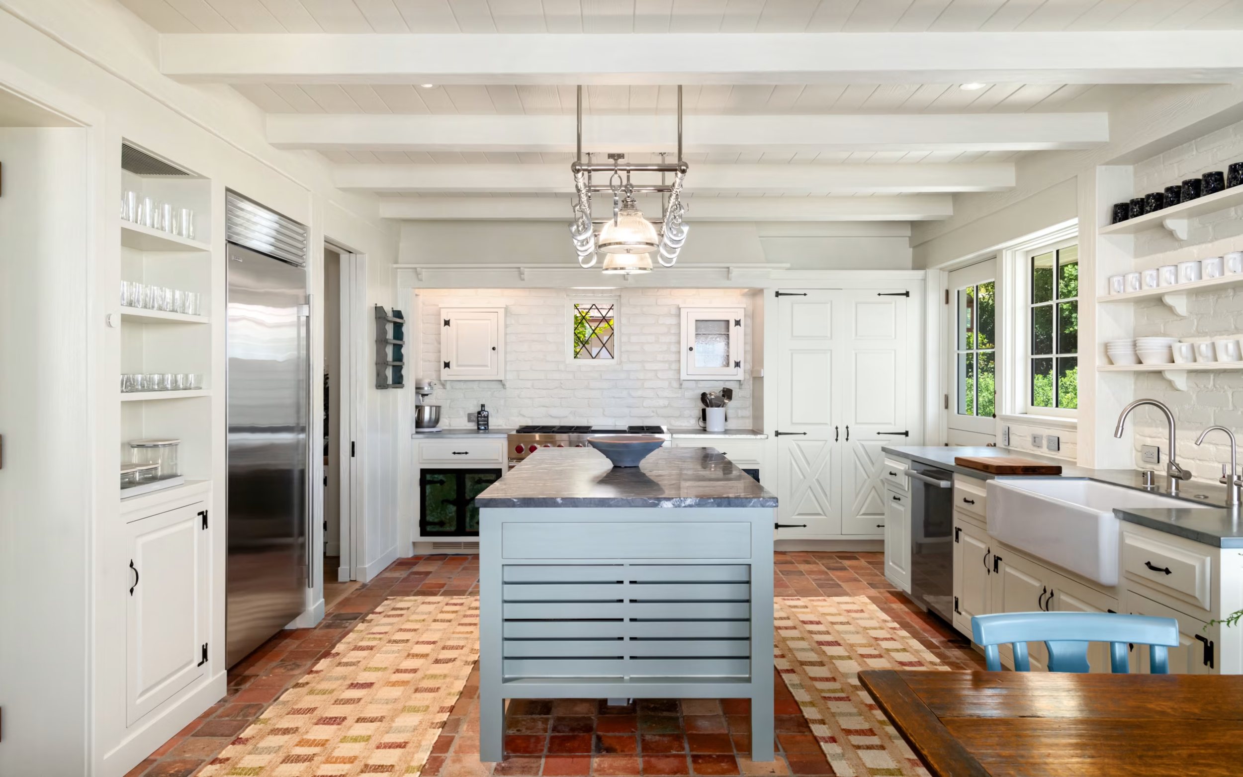 Kitchen with terracotta floors and open shelving