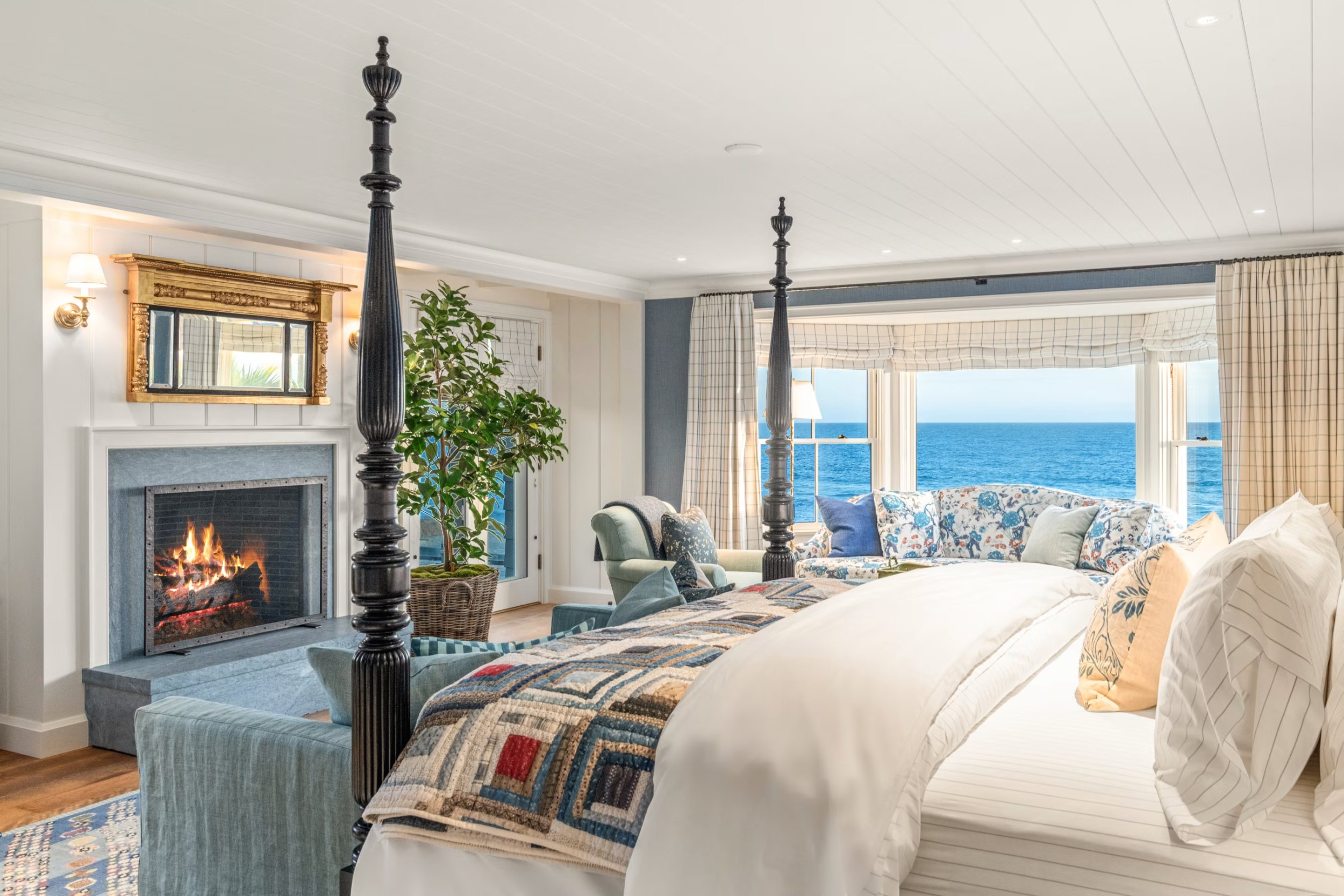 Primary bedroom with fireplace and ocean bay