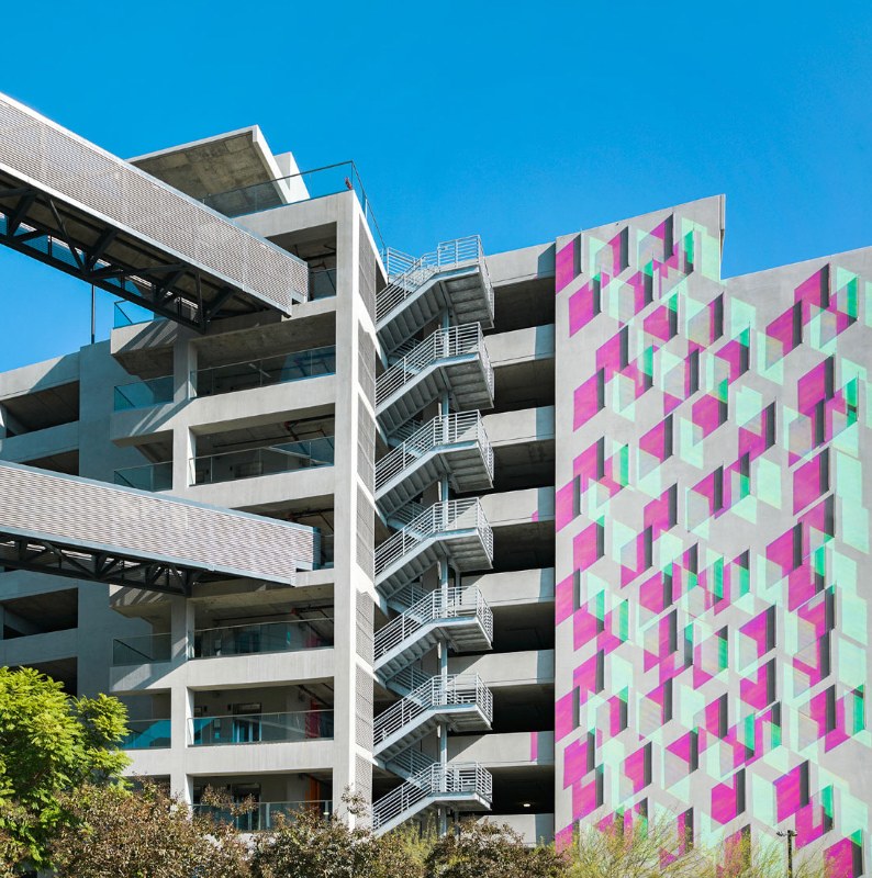 Parking structure with exterior stair and sky bridges