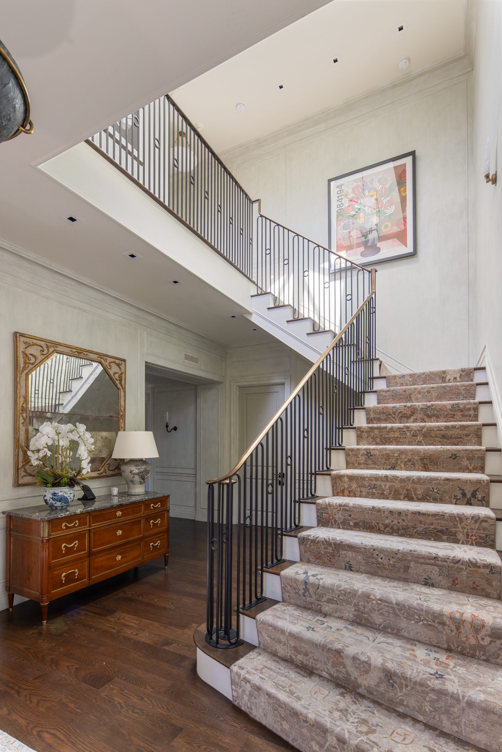Entry hall and iron stair with brass rail