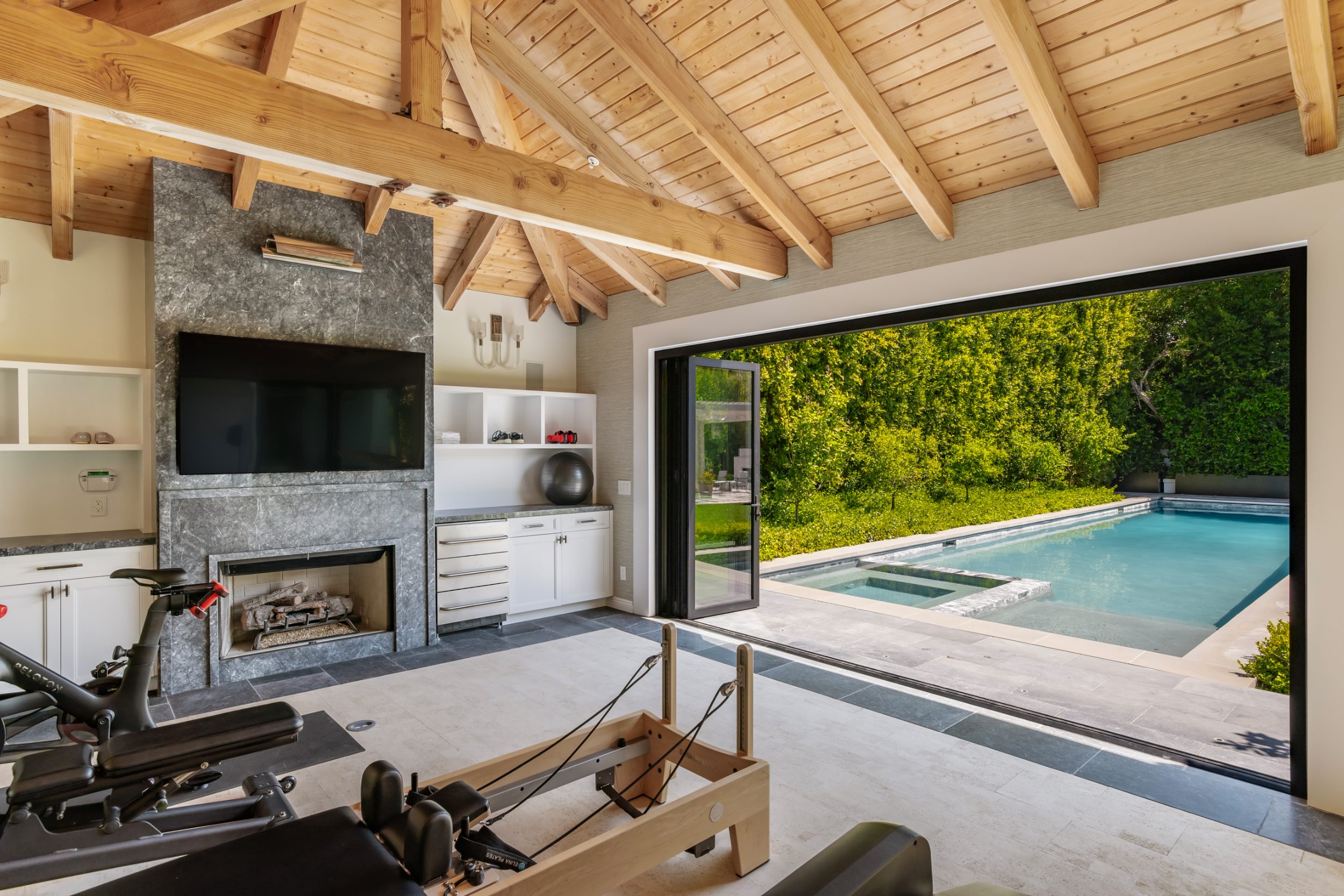 Guest house gym opening fully to the pool