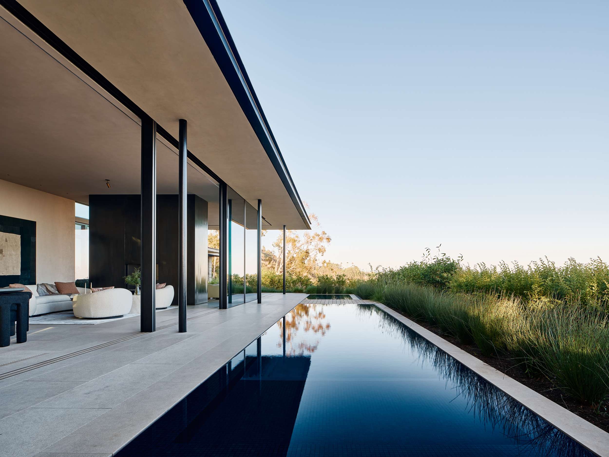 Dark lap pool along the living pavilion