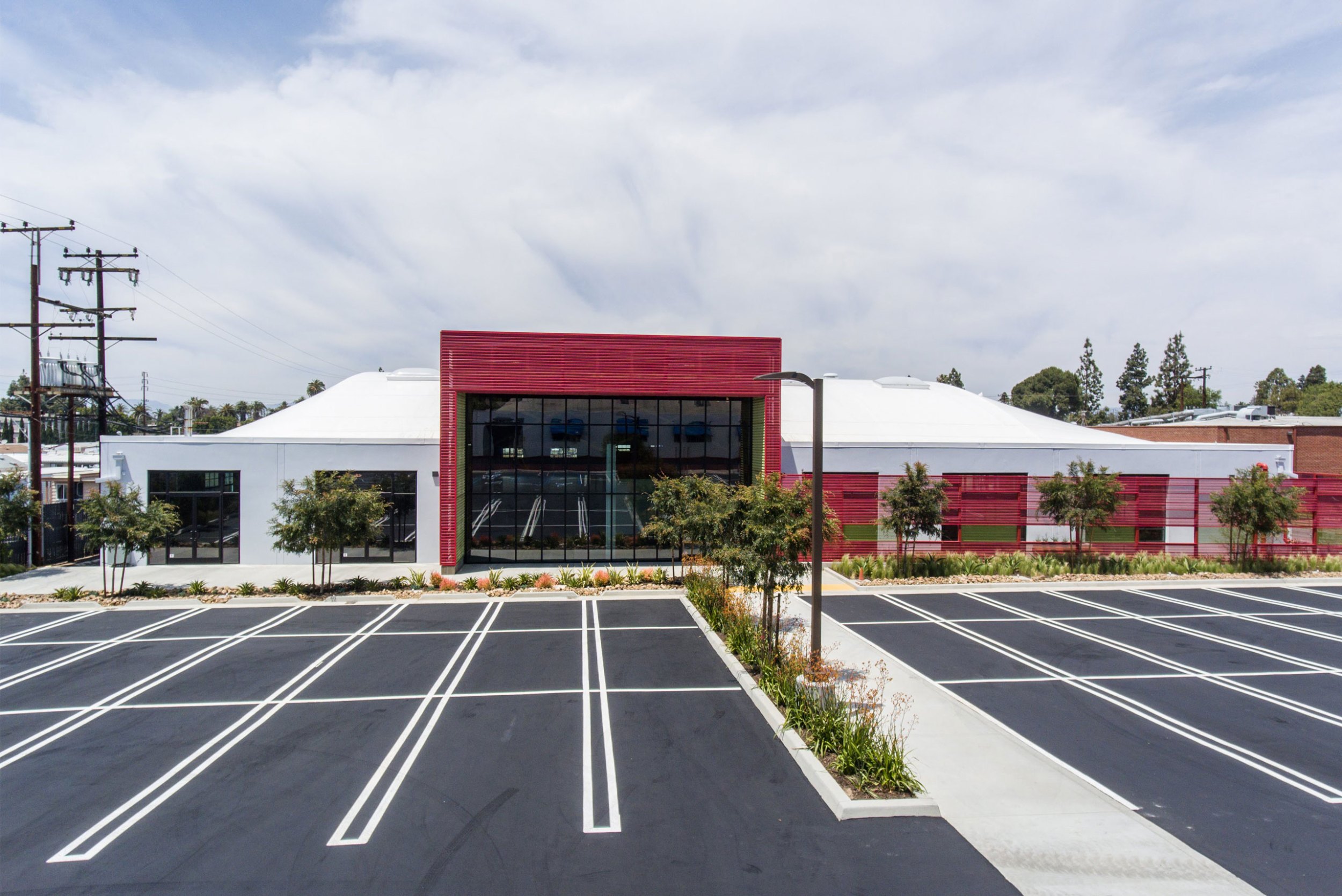 Glass entry framed in red screens