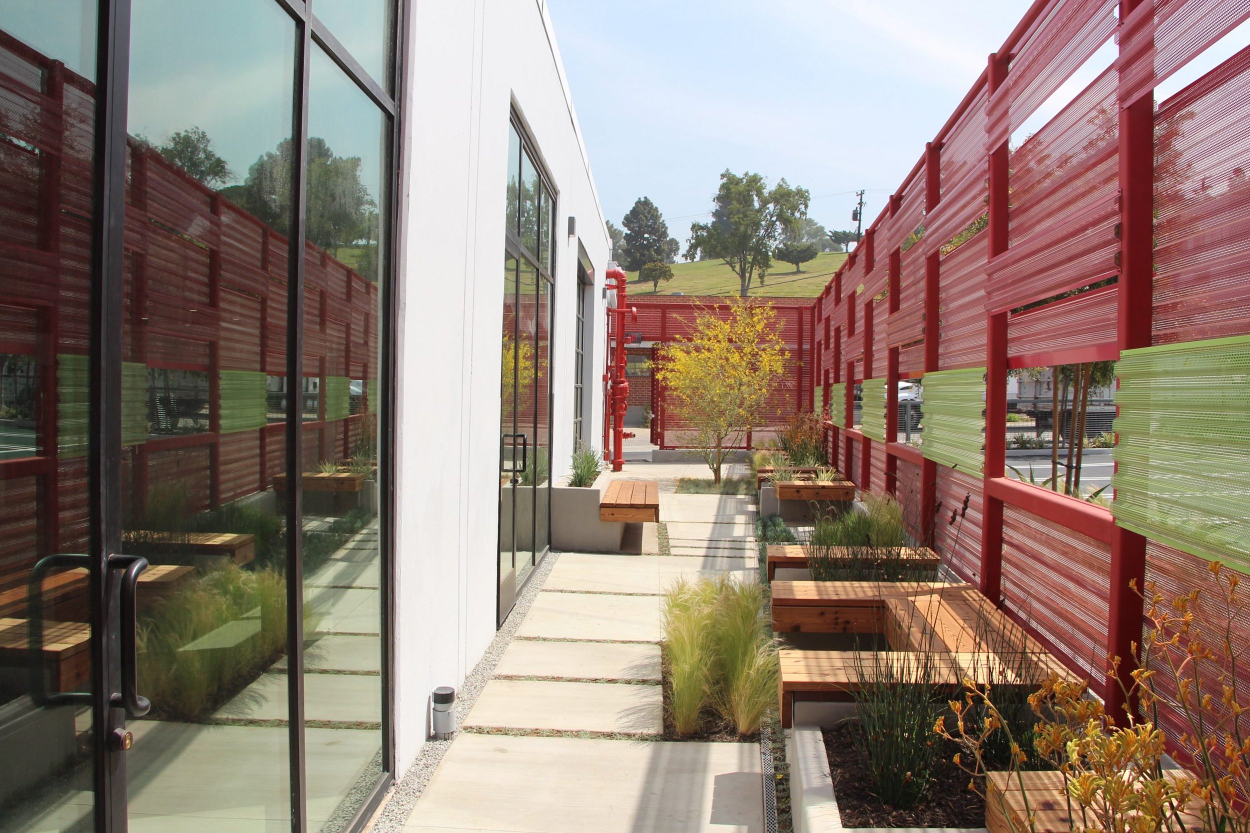 Side courtyard behind the red screen wall