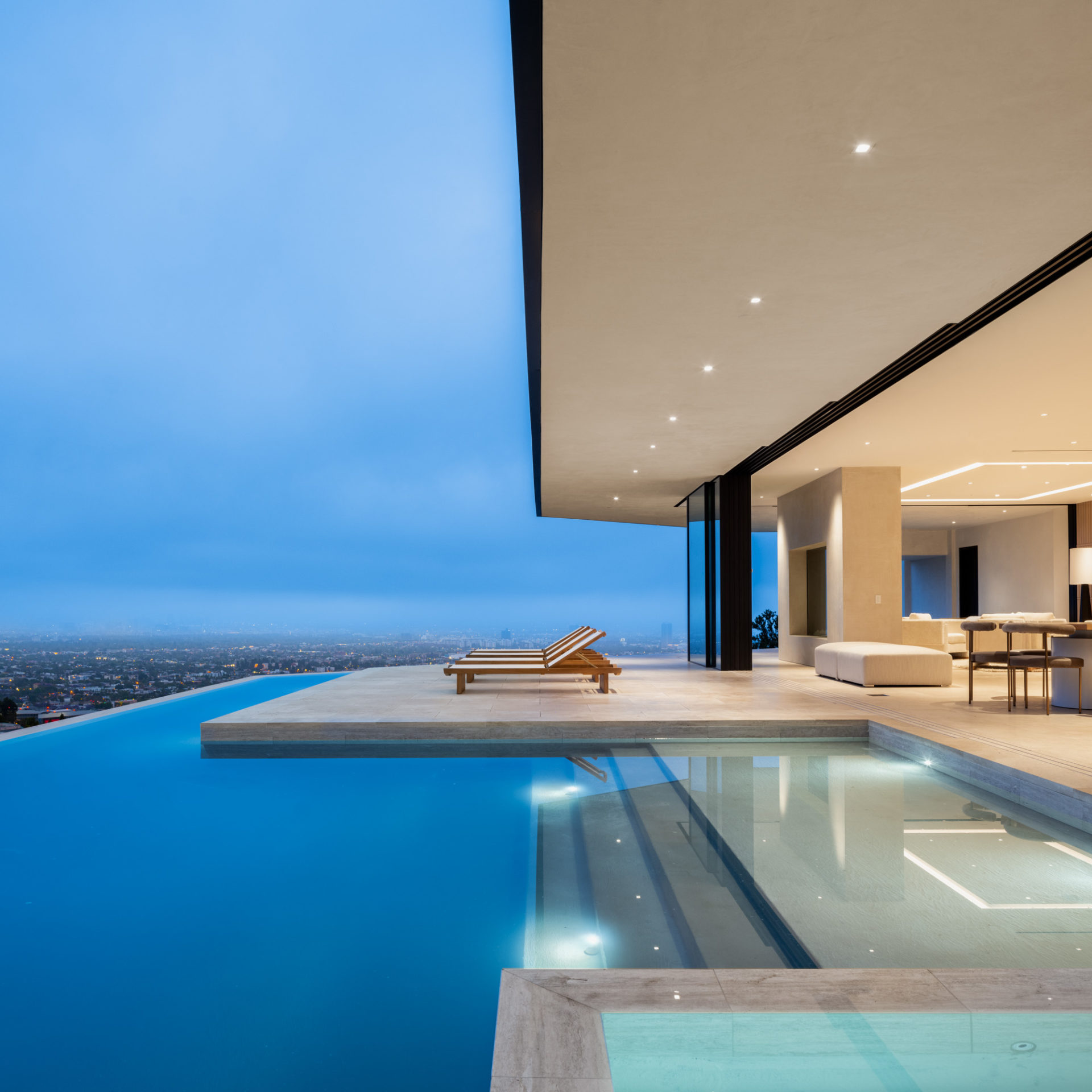 Tanager Way infinity pool and lounge at dusk